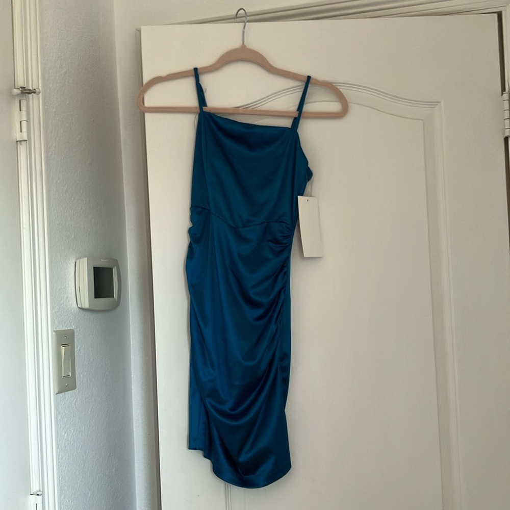 Teal dress perfect for a formal occasion. Brand new with tags.